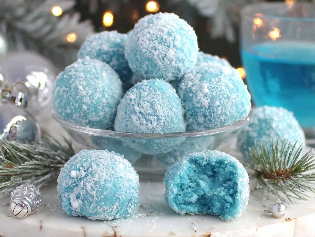Beautiful blue Christmas truffles coated in sparkling sanding sugar on marble surface with holiday decorations - easy no-bake recipe
